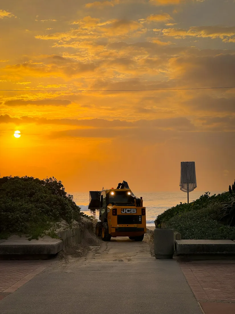 Haul vehicle silhouetted against a sunset